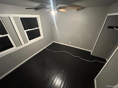 Empty room featuring hardwood / wood-style flooring and ceiling fan