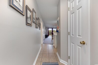 Hall featuring light tile patterned floors