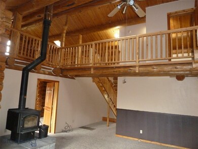 Living area, looking up to loft area.