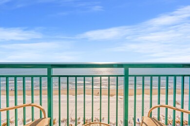 Balcony featuring a view of the beach and a water 
