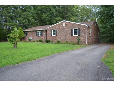 Front of house w/ paved circular driveway