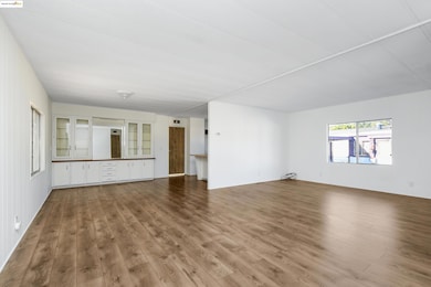 Unfurnished living room featuring wood finished floors