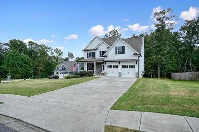View of front of home featuring concrete driveway and a garage