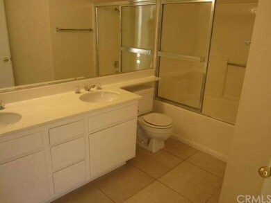 Full bathroom with dual sinks.