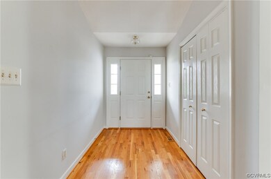 Foyer entrance featuring light hardwood / wood-sty