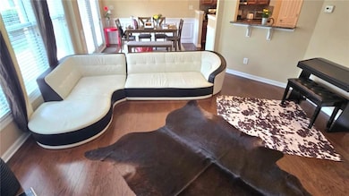 Living room featuring baseboards and wood finished floors