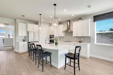 Kitchen featuring belectric stovetop, white cabine