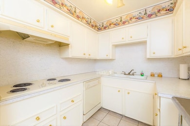 This cozy kitchen features bright white cabinets,
