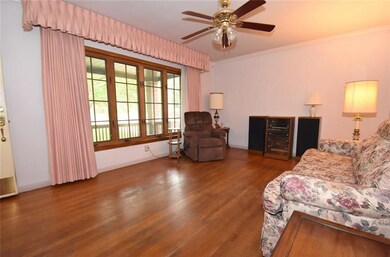 The living room has hard wood floors and a beautif