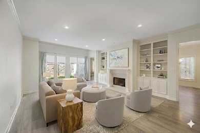 Living area featuring ornamental molding, healthy amount of natural light, built in shelves, a fireplace, and recessed lighting