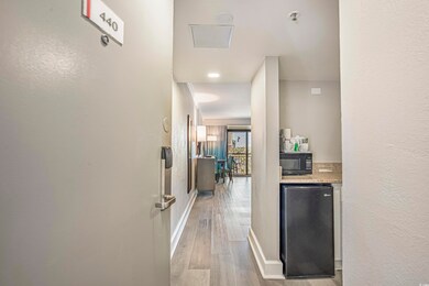 Hall featuring wood finished floors and baseboards