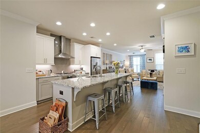 Kitchen featuring wall chimney range hood, a kitch