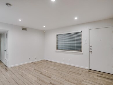 Entryway with baseboards, visible vents, light wo
