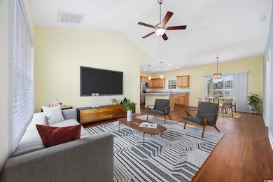 Living room with dark wood finished floors, lofted