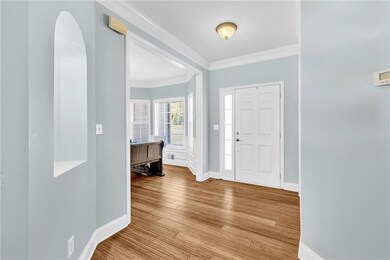 Entrance foyer featuring arched walkways, crown mo