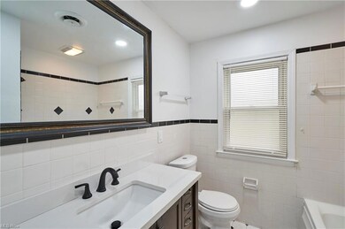 Bathroom featuring toilet, tasteful backsplash, ti