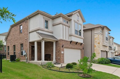View of front facade featuring a garage, stucco s