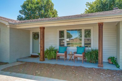 Relax on this front porch featuring new cedar columns and painted concrete,
