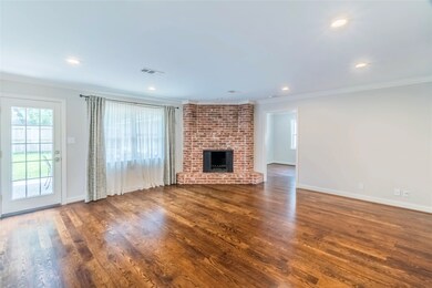 The Family Room (18 x 17) is anchored by the brick