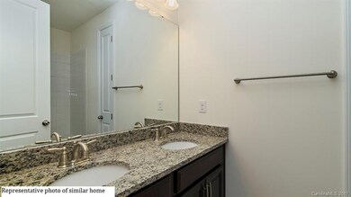 Full first floor bathroom with two sinks between t