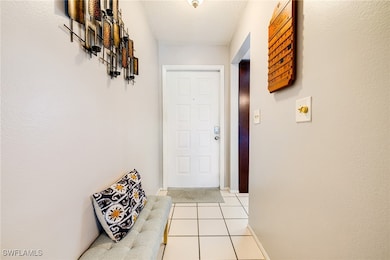 Doorway with light tile patterned floors, a textur