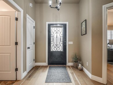 Beautiful iron door adorns this spacious entryway!