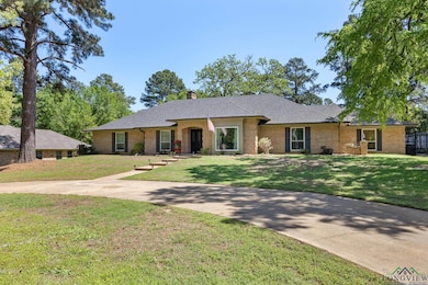 Single story home featuring brick siding, a front 