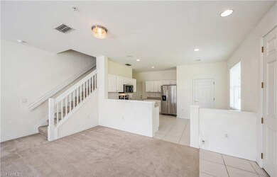 Kitchen featuring light tile patterned flooring, a peninsula, stainless steel appliances, recessed lighting, and white cabinets