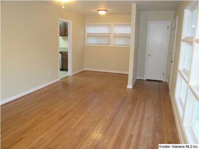 Sunny living room/dining room combo with gleaming 