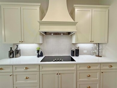 Kitchen with light countertops, backsplash, premiu