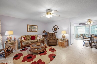 Living area with ceiling fan, light tile patterned