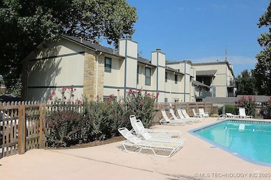 Community pool with fence and a patio