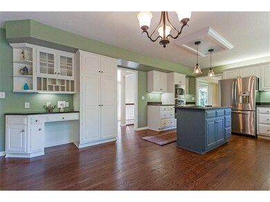 Spacious kitchen with dining area and computer des