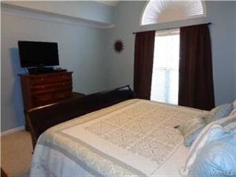 AND THE MAIN BEDROOM HOLDS A ROUNDED PICTURE WINDO