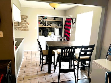 Dining room with light tile floors and laundry area
