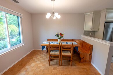Dining area featuring a chandelier and baseboards