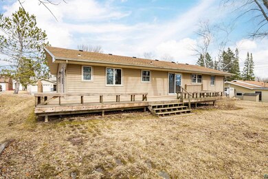Back of property featuring a yard and a deck