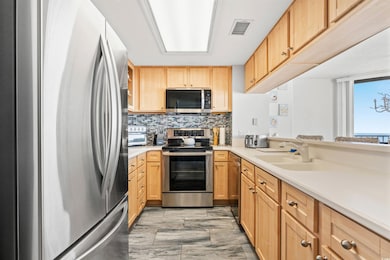 Kitchen featuring tasteful backsplash, sink, stain