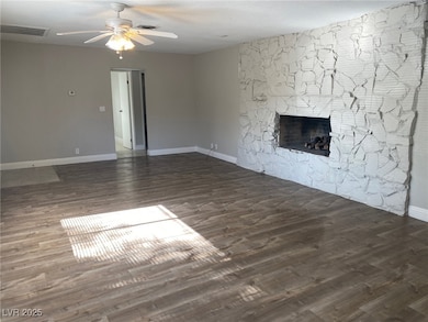 Unfurnished living room with ceiling fan, wood fin