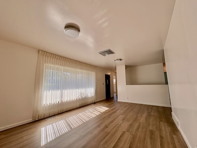 Unfurnished room with wood finished floors and baseboards