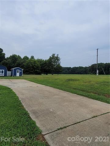 Concrete driveway and view of side yard.