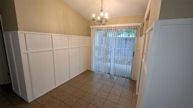 Unfurnished dining area with a chandelier, vaulte
