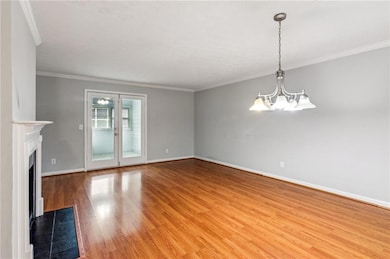 Unfurnished living room with a chandelier, light w