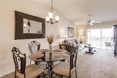 Carpeted dining room with ceiling fan with notable