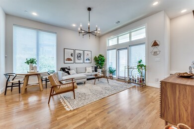 Living room with recessed lighting, light wood-style floors, and a chandelier