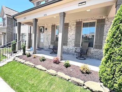 Property entrance with a porch and brick siding