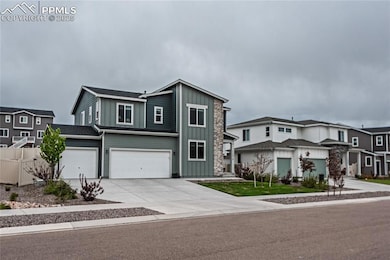 View of front facade with board and batten siding, concrete driveway, a garage, and a residential view