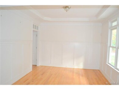 Formal dining room with elaborate moldings with ha