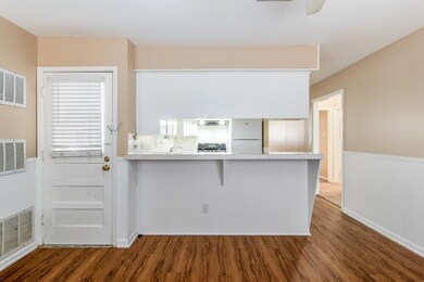 Kitchen featuring wood finished floors, freestand