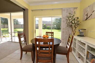Breakfast nook is light & bright & features crown molding.